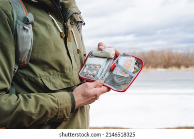 A Bag With Medicines, A First-aid Kit In The Hands Of A Tourist, Tablets In A Package, A Patch For A Wound, A Band-aid, Emergency Medical Care In The Forest, Health Protection. High Quality Photo