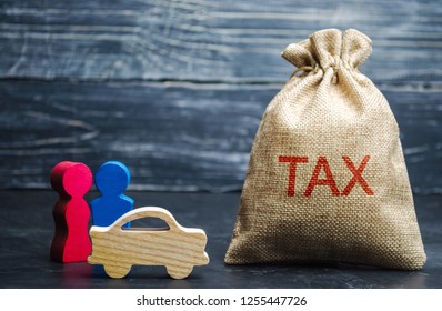 A Bag With Money And The Word Tax And A Car With Family. Concept The Taxes Payment For Auto. Vehicle, Road, Disc Tax. Is An Annual Tax That Is Levied As An Excise Duty And Which Must Be Paid