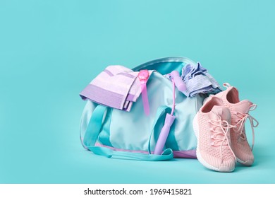 Bag with sportswear, equipment and shoes on color background - Shutterstock ID 1969415821