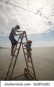 Bagan Lalang, Selangor Circa March 2016.A Man Helping Tourist Down From The Flying Fox Activity.