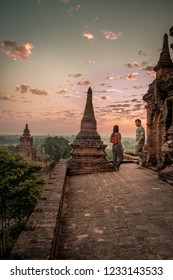 Bagan Old Ruins Temple's And Pagoda During Sunrise, Man And Woman Couple Watching Sunrise In Old Bagan