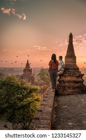 Bagan Old Ruins Temple's And Pagoda During Sunrise, Man And Woman Couple Watching Sunrise In Old Bagan