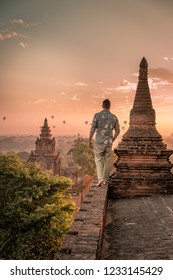 Bagan Old Ruins Temple's And Pagoda During Sunrise, Man And Woman Couple Watching Sunrise In Old Bagan