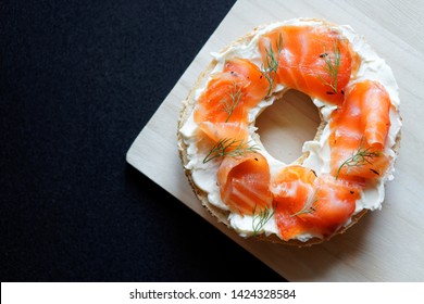 A Bagel With Cream Cheese, Cured Salmon(lox,gravlox) And Dill, Top View, Black Background