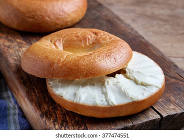 Bagel With Cream Cheese On Wooden Table