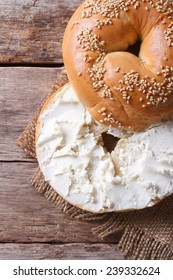 Bagel With Cream Cheese And Sesame Close-up On The Table. Top View Of The Vertical 