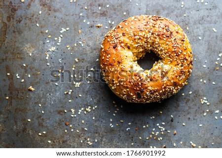 Bagel with everything seasoning on a dark surface