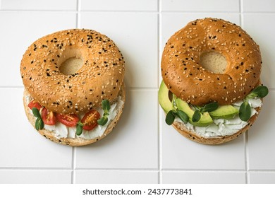 Bagels with butter and herbs on a white table for breakfast