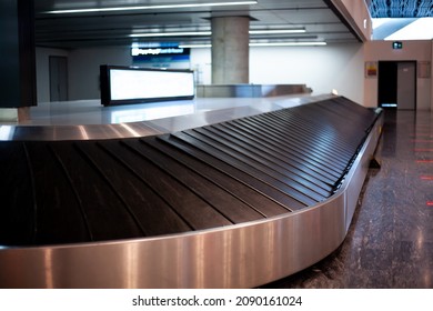 Baggage Carousel At The Airport. Empty Luggage Carousel In Arrival Hall. Airport Without Passengers Due Canceled Flight.