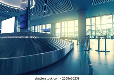 Baggage Carousel At Arrival Airport Hall, Empty Transporter Tape, Moving Luggage Belt, Copy Space With Window Sunlight Background