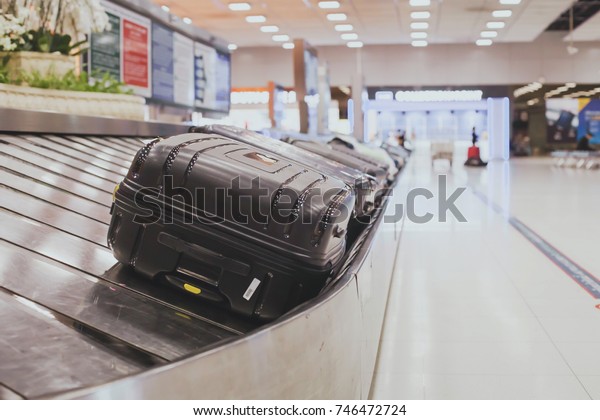 baggage claim area in the airport, abstract
luggage line  with many
suitcases