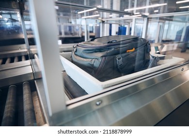 Baggage On Conveyor Belt During Airport Security Check Before Flight