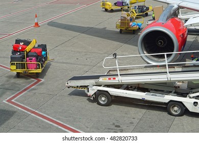 Baggage Trolly And Belt Loader Near Airplane