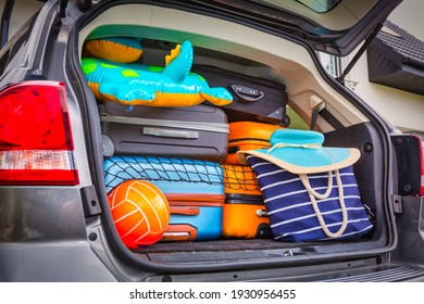 Baggages in the car trunk packed and ready to go for holidays - Powered by Shutterstock