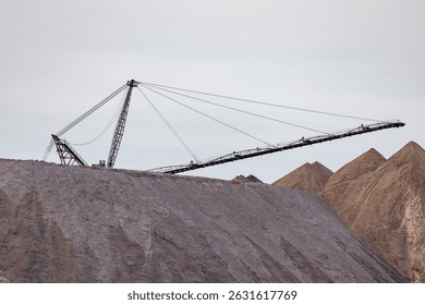 Bagger operation in surface mine. A backloader and a bucket wheel excavator in a lignite mine. Industrial stone production, crushed stone production, stone mining, crushed stone mining plant
