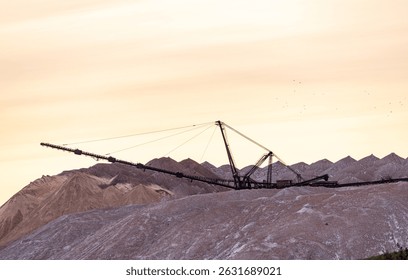 Bagger operation in surface mine. A backloader and a bucket wheel excavator in a lignite mine. Industrial stone production, crushed stone production, stone mining, crushed stone mining plant
