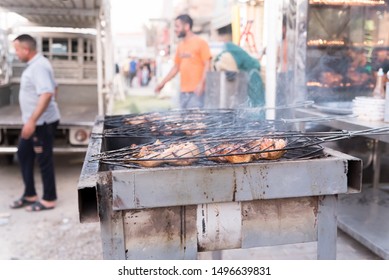 Baghdad, Iraq – June 28, 2019: Barbeque On The Grill.Preparing Meat For Sale.Busy Workers