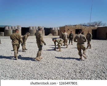 Baghlan, Afghanistan, March 20, 2011:  U.S. Army Soldiers Teach Afghan Soldiers How To Play Football Within An Afghan Army Compound.