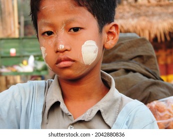Bago  Myanmar - April 16, 2013: young boy with traditional thanaka paste on his face
