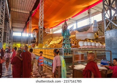 Bago, Myanmar - December 02 2012 : interior of the famous laying reclining buddha and buddhist monks visiting