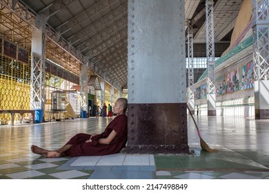 BAGO, MYANMAR - MARCH 04 : Unidentified Young monk sitting at The Shwethalyaung Buddha, The Statue is a reclining Buddha, which has a length of 55 metres and height of 16 metres on Mar 04, 2015