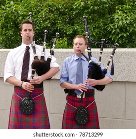 Bagpipe duo in full dress including kilt, playing in Ottawa, Canada.