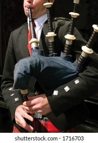 Bagpiper Blowing His Pipes In Edinburgh, Scotland.