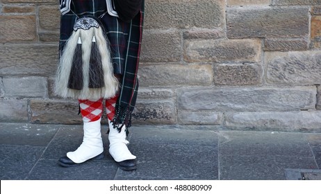 Bagpiper Dressed In Kilt Playing Bag Pipes