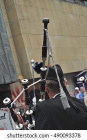 Bagpiper Dressed In Kilt Playing Bag Pipes