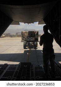 BAGRAM AIR BASE, AFGHANISTAN - CIRCA JULY 2012: Air Force Crew Member Watches As Cargo Is Onloaded Aboard A MC-130P At Bagram Air Base, Afghanistan