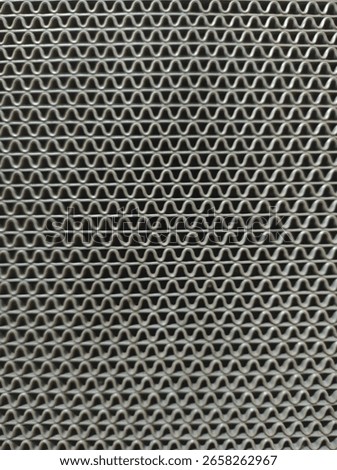 baground, a material structure with a regular, dense, wavy pattern. This pattern resembles a sinusoidal or horizontal zigzag shape arranged in parallel and layers.