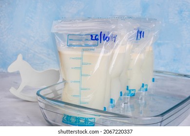 Bags with breast milk on blue background. Milk bank. Expressing breast milk. Breast-feeding. Freezing and storing milk. Donated.