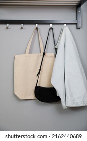 Bags And Clothes On Coat Rack In Hallway. Interior Element