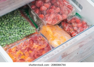 Bags With Frozen Vegetables In Refrigerator. Frozen Fruits And Vegetables.