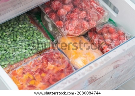Bags with frozen vegetables in refrigerator. frozen fruits and vegetables.