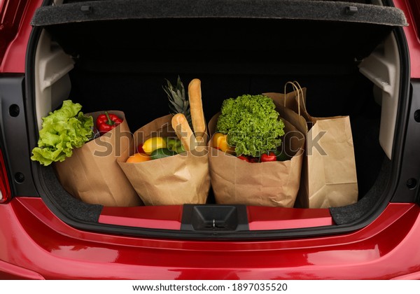 Bags full of
groceries in car trunk, closeup
view