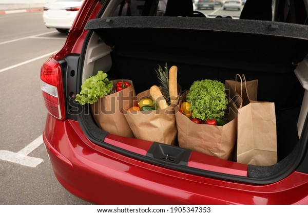 Bags full of
groceries in car trunk
outdoors