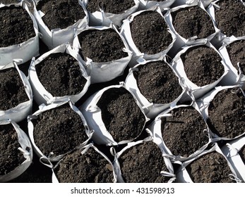 Bags Of Topsoil Stacked In Rows Ready For Landscaping