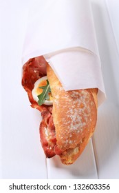 Baguette With Bacon And Egg Packed In Paper