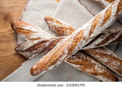 Baguette and bread. Craft bakery. Homemade pastries. Fresh bread in the bakery. French baguette - Shutterstock ID 2155091799
