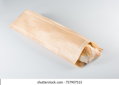 Baguette in paper bag isolated on white background