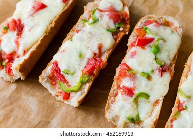 Baguette pizza sandwiches. Freshly grilled baguette pizza sandwiches with cheese, chicken, green pepper, tomatoes and italian spices
