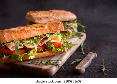 Baguette sandwich with cheese, ham, tomatoes and vegetables - Shutterstock ID 2180951639