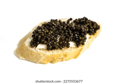 Baguette slice with black caviar and butter isolated over white. Natural sturgeon luxury delicacy sandwich closeup. Seafood delicatessen and bread appetizer. - Shutterstock ID 2275553677