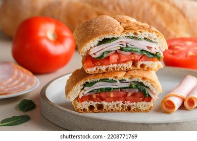 Baguette stuffed with tomatoes, onions, ham, spinach, basil. Delicious sandwich. A multi-layered snack for gourmets. Healthy breakfast. Mediterranean cuisine. Selective focus - Shutterstock ID 2208771769