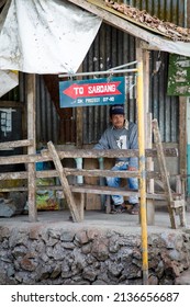 BAGUIO CITY, PHILIPPINES - JANUARY 2019: In the rural outskirts of Baguio a vendor waits for tourists as they pass through for Sabdang.  The primary income for these small towns comes from tourism. 