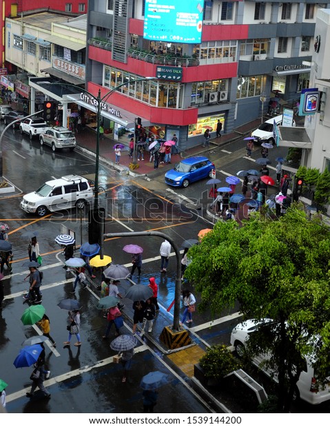 Baguio City, Philippines - May\
08, 2019 : The busy Session Road of Baguio City on a rainy\
afternoon.