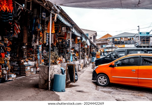 BAGUIO, PHILIPPINES -\
Dec 19, 2017: A street with small shops and parked cars in Baguio\
City, Philippines