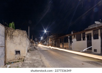 Camaçari, Bahia, Brasil. 04 jan. 2022.
Track illuminated with artificial light from poles and headlights and moving car. - Shutterstock ID 2277336349