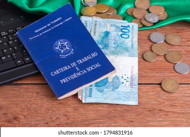 Bahia, Brazil, August 8, 2020. Translation: Federative Republic of Brazil, Ministry of Labor. Brazilian Work Card. Workbook with notebook, one hundred reais bank notes and coins. Top view - Shutterstock ID 1794831916